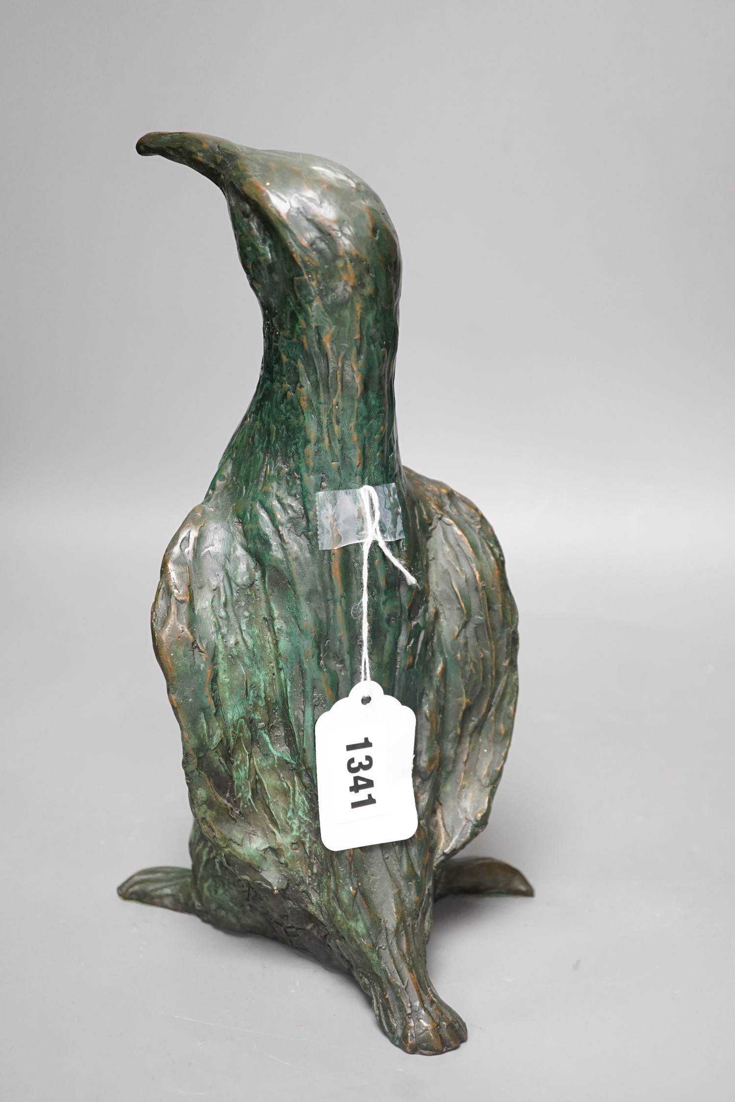 A green patinated bronze model of a penguin, monogrammed and numbered 3/6 29cm